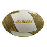 The Gilbert Limited Edition USA Rugby 50th Anniversary Supporters Ball features white and gold colors, "USA RUGBY," stylized flag patterns, and is perfect for fans.