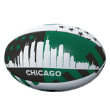 The Ireland v All Blacks Chicago 2025 Supporters Ball by Gilbert features a green, black, and white Chicago skyline with stars and "CHICAGO"—a perfect keepsake for rugby fans.