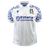 An Italy 24/25 Replica Away Jersey by Macron in white, with blue decorative patterns on the sleeves, showcasing a Renaissance-inspired graphic along with the Italian Rugby logo and Vittoria Assicurazioni branding on the front.