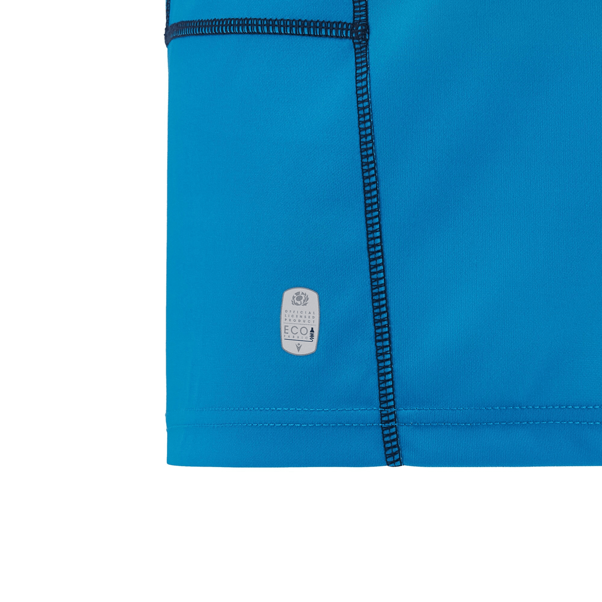 Close-up of a blue Scotland Replica Away Jersey 24/25 by Macron, showcasing visible stitching and a small eco-friendly label in the corner.