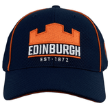 Edinburgh Baseball Cap 24/25 by Macron with orange trim, featuring an orange castle logo and "Edinburgh" in white, along with "Est. 1872." Perfect for Edinburgh Rugby fans looking to show their team spirit.