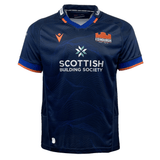 The Edinburgh 24/25 Replica Home Jersey by Macron is a home jersey in navy blue with bold orange accents, showcasing the Edinburgh logo and "Scottish Building Society" sponsor.