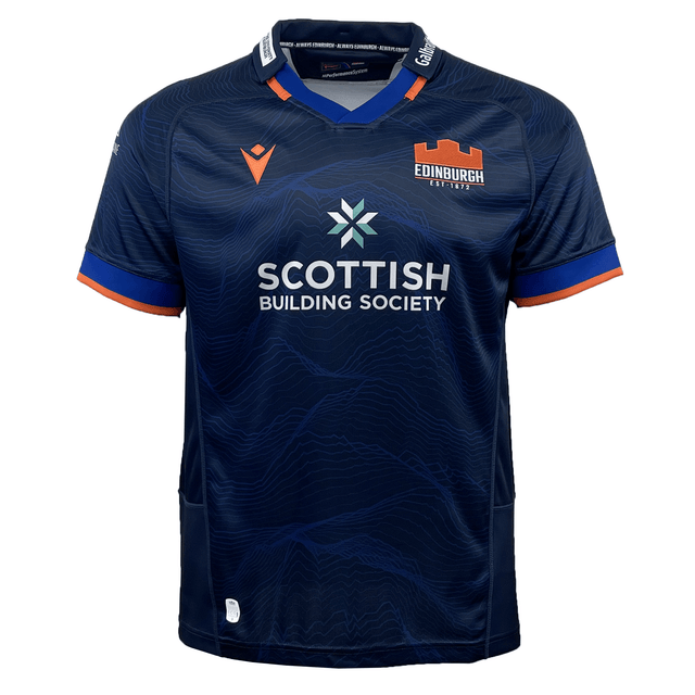 The Edinburgh 24/25 Replica Home Jersey by Macron is a home jersey in navy blue with bold orange accents, showcasing the Edinburgh logo and "Scottish Building Society" sponsor.