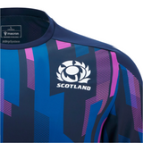 Close-up of the Scotland 25/26 Player Warm-Up Shirt by Macron, in blue and purple with a patterned design, featuring the Scotland rugby team logo and Macron branding on the shoulder and neckline.