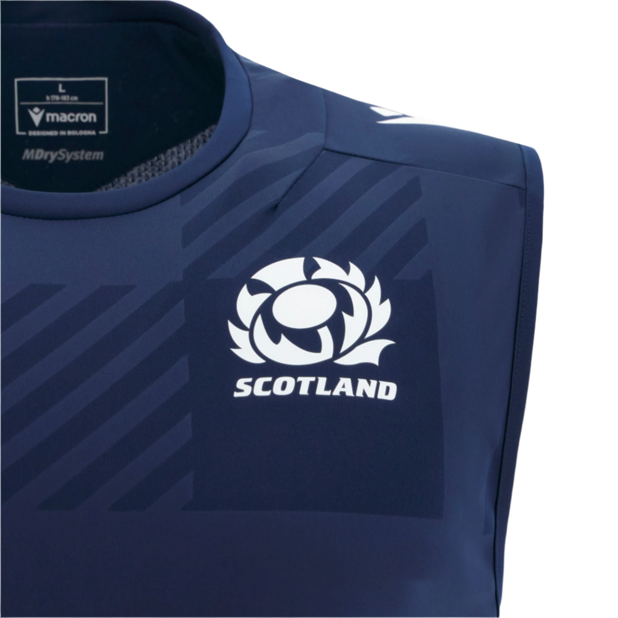 Close-up of the Scotland 25/26 Player Training Singlet by Macron in navy blue, showing the Scottish Rugby logo, "SCOTLAND" text, and Macron brand logo on the upper chest.