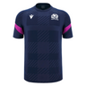 The Scotland 25/26 Player Training T-Shirt by Macron features a navy blue checkered pattern, white chest logos, and pink sleeve stripes—an ideal moisture-wicking sports tee for fans and athletes from Macron.