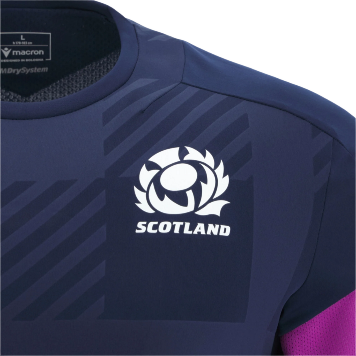 Close-up of the Scotland 25/26 Player Training T-Shirt by Macron in navy, featuring the team logo, "Scotland," and the Macron logo on the collar. Made from moisture-wicking fabric for comfort.