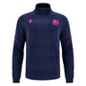The Scotland SRU 25/26 Player Travel 3D Fleece by Macron is a navy long-sleeve top with soft 3D fleece, a quarter zip, pink accents, and the Scotland SRU rugby logo on the chest.