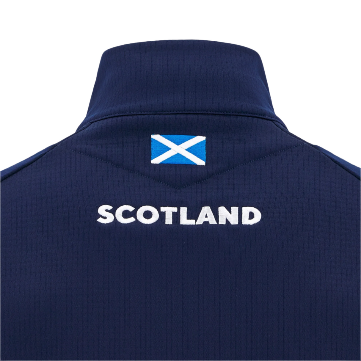 Back view of the Scotland SRU 25/26 Player Travel 3D Fleece by Macron in navy, featuring "SCOTLAND," a small Scottish flag below the collar, and made from soft 3D Fleece for superior comfort.