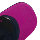 A close-up of the Scotland 25/26 Baseball Cap by Macron, showcasing a vibrant pink brim with detailed stitching and a dark blue crown—ideal for Scottish Rugby fans.