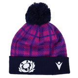 The Scotland 25/26 Pom-Pom Beanie by Macron features a purple and pink tartan knit, a navy pom-pom, two embroidered Macron logos on the navy cuff, and is made by the brand Macron.