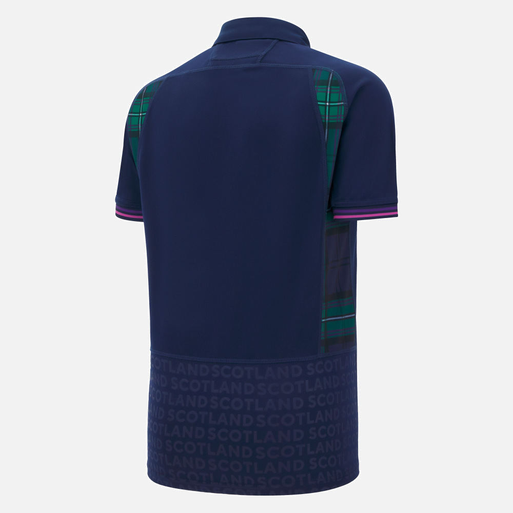 Back view of the Scotland WRWC25 Replica Home Jersey by Macron—a navy blue jersey with green and blue tartan panels, purple-striped sleeve cuffs, and "SCOTLAND" printed repeatedly along the lower back.