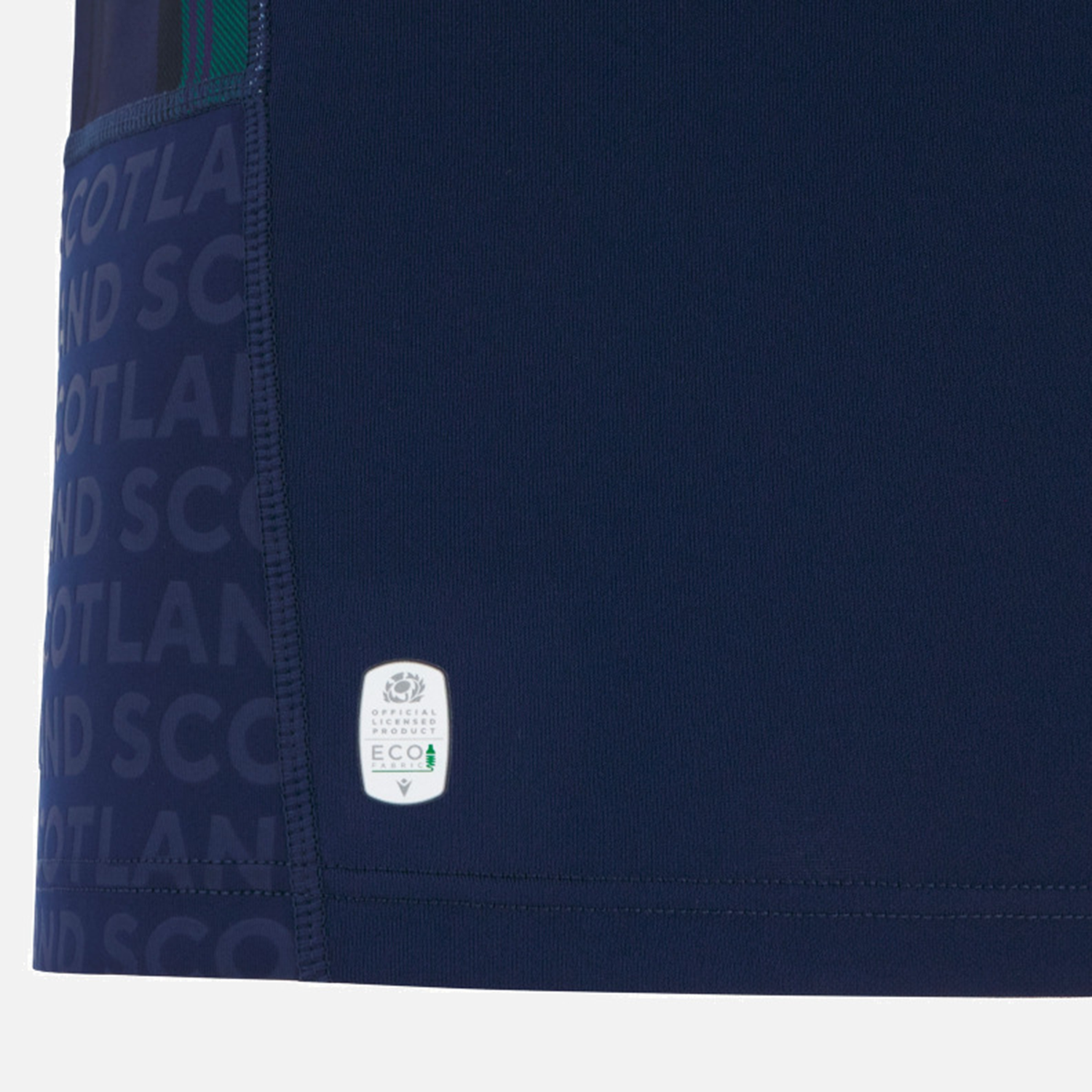 Close-up of the Scotland WRWC25 Replica Home Jersey by Macron, featuring "SCOTLAND" in lighter blue and a white ECO tag, highlighting the details of this navy blue rugby jersey.