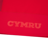 The Wales 25/26 Authentic Matchday Home Jersey by Macron features bold “CYMRU” print in a lighter red near the hem, inspired by classic Wales Rugby designs.