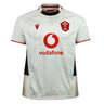 The Wales 25/26 Replica Away Jersey by Macron is a white rugby jersey with subtle topographic patterns, red trim, Vodafone sponsor logo, and the WRU emblem on the chest.