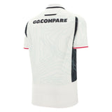 The Wales 25/26 Replica Away Jersey by Macron features a white design with subtle light blue contour patterns, black side panels, red sleeve trim, and "GO.COMPARE" text on the upper back.