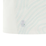 Close-up of a white fabric with light blue contour lines and an eco-friendly certification label near the hem—part of the Wales 25/26 Replica Away Jersey by Macron.