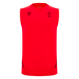 The Wales 25/26 Player Training Singlet by Macron is sleeveless and bright red, featuring black logos, accents, the WRU crest on the left chest, and a Macron logo on the right chest.