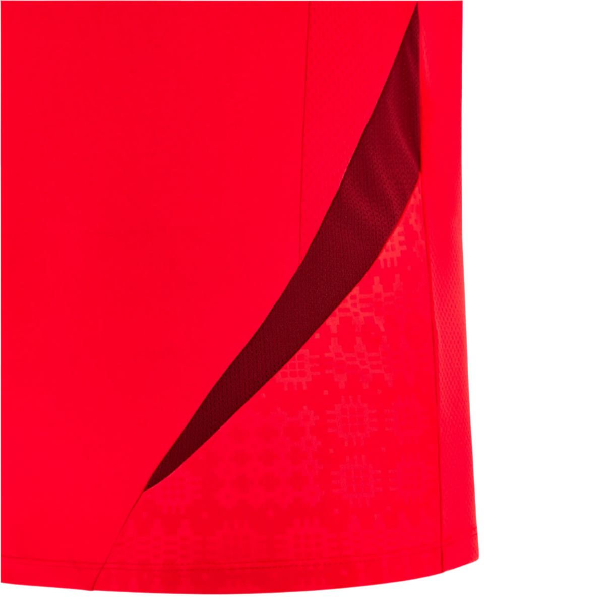 Close-up of the Wales 25/26 Player Training Singlet by Macron, featuring red performance polyester, a darker red mesh panel, and a subtle geometric pattern near the side seam.