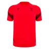 The Wales 25/26 Player Training Shirt by Macron is a red short-sleeve rugby top with black accents, featuring the Macron logo and Welsh rugby crest—ideal for WRU training.