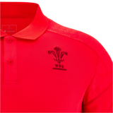 Close-up of the Wales 25/26 Player Travel Poly Polo by Macron in red, featuring the Welsh Rugby Union (WRU) logo and Macron branding on the chest and collar.