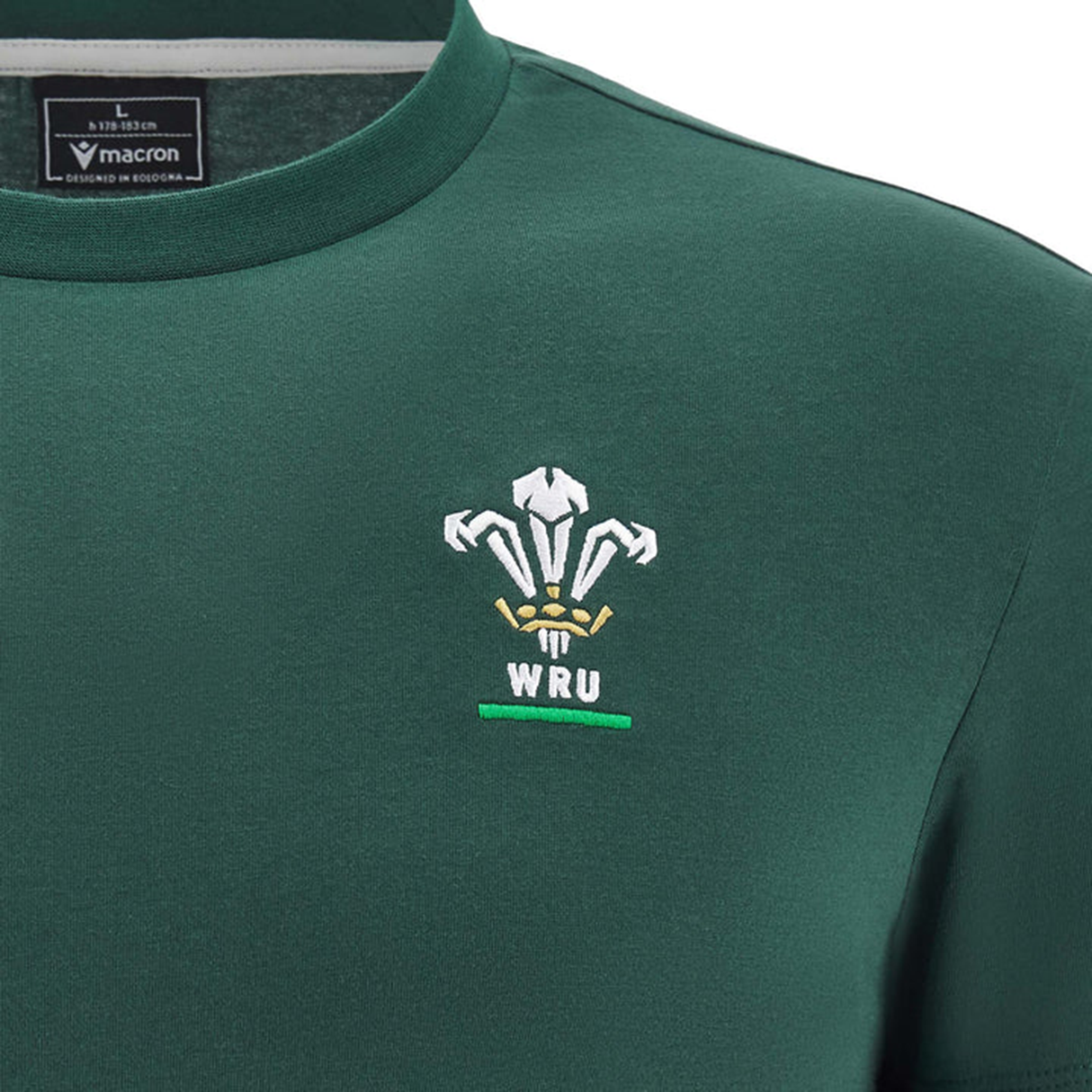 The Wales 25/26 Country Outline Cotton Fan T-Shirt by Macron features a green design, an embroidered white WRU logo, and a Macron label on the inside collar—perfect for any WRU supporter's collection.