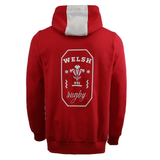 The Wales 25/26 Welsh Rugby Cotton Fan Hoodie by Macron features a red design, a white hood panel, and the official WRU emblem printed on the back.