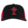 The Wales 25/26 Trucker Cap by Macron features a bold red Welsh Rugby Union logo on the front and a striking red mesh back.