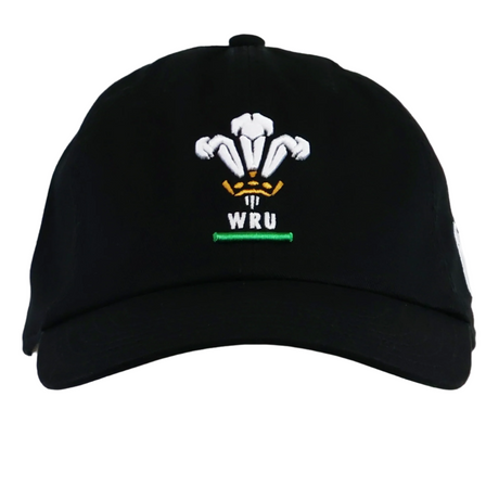 The Wales 25/26 Dad Hat by Macron is a black baseball cap featuring the Welsh Rugby Union logo embroidered in white, gold, and green—perfect for any rugby supporter.