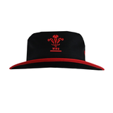 The Wales 25/26 Bucket Hat by Macron features a bold red brim and the WRU logo embroidered on the front—ideal for fans of the Wales WRU collection.