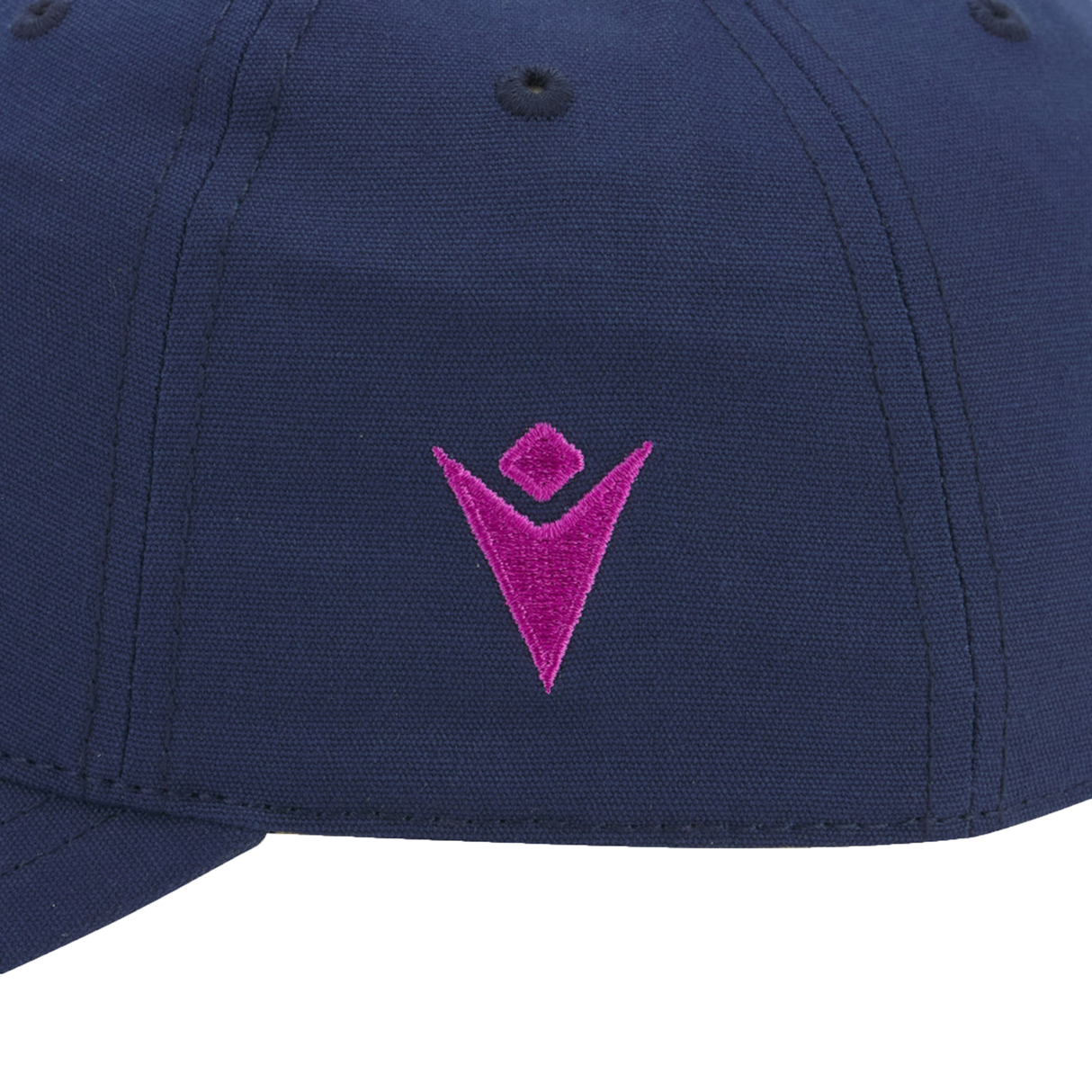 Close-up of the Scotland 25/26 Dad Cap by Macron in navy blue, featuring a pink embroidered V-shaped logo with a diamond above it—a subtle nod to the iconic thistle.