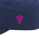 Close-up of the Scotland 25/26 Dad Cap by Macron in navy blue, featuring a pink embroidered V-shaped logo with a diamond above it—a subtle nod to the iconic thistle.