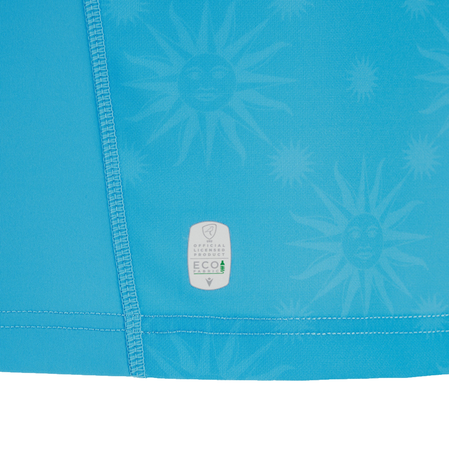 Close-up of the Uruguay URU 25/26 Replica Home Jersey by Macron, featuring blue fabric with sun motifs, detailed stitching, and a small “Official Product ECO” label—showcasing meticulous Macron craftsmanship.