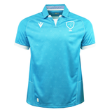The Uruguay URU 25/26 Replica Home Jersey by Macron features light blue short sleeves, white trim, a stylized bird crest with “URU” text on the chest, and subtle sunburst patterns, all made from EcoFightex fabric.