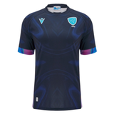 The Uruguay URU 25/26 Replica Training Jersey by Macron features short sleeves, dark blue color with subtle patterns, and light blue URU and Macron logos on the chest.