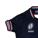 The Youth USA Rugby 24/25 Home WRWC Jersey by Macron is a navy blue youth rugby top with red, white, and blue trim on the sleeve and collar, featuring the Rugby World Cup logo and "Women's ENG25" text.