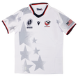 The Youth USA Rugby WRWC 25 Home Jersey by Macron features gray star patterns, the "USA Rugby" logo, WRWC 25 emblem, American flag patch, plus red, white, and blue trim on the sleeves and collar.