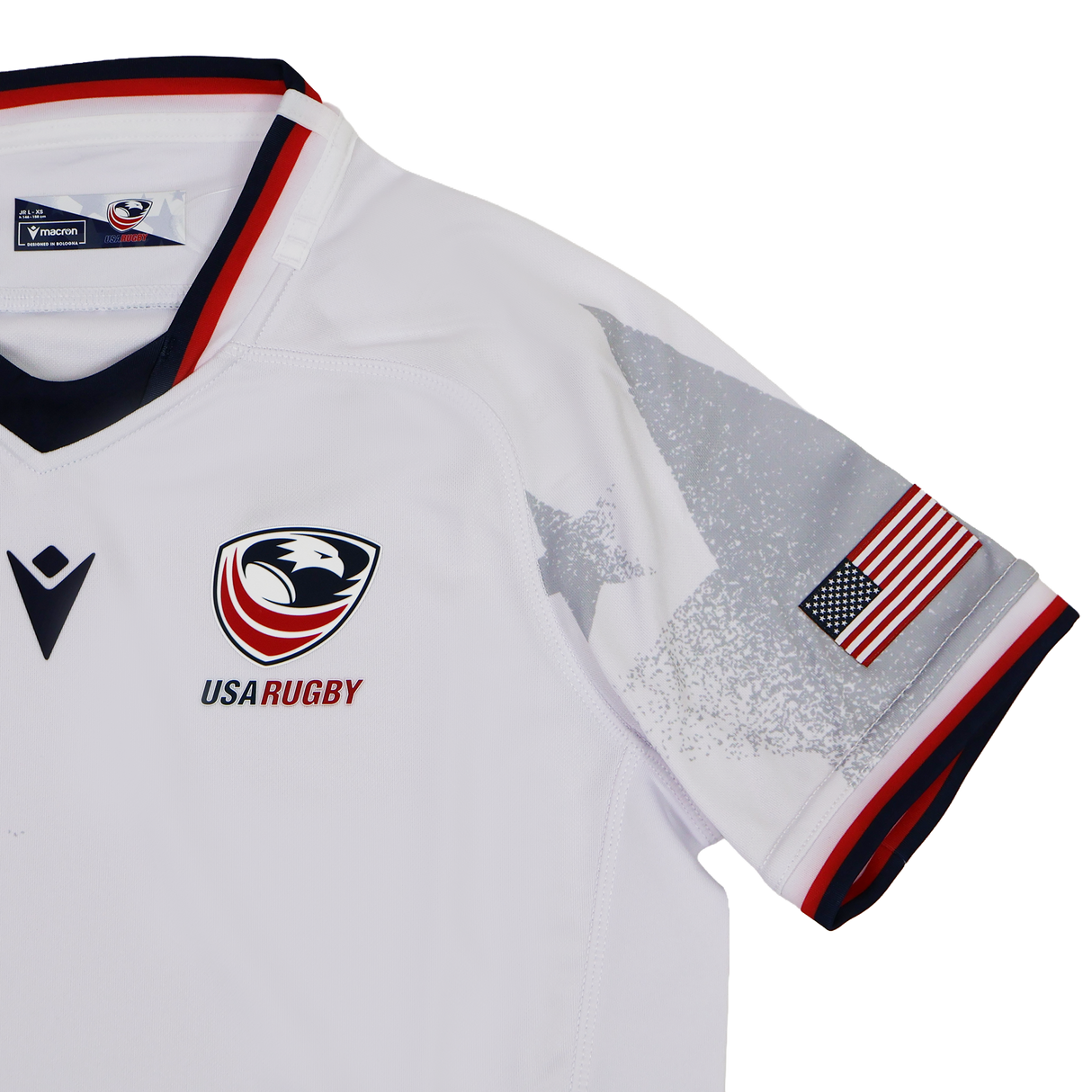 The Youth USA Rugby WRWC 25 Home Jersey by Macron features the team logo, WRWC 25 detail, an American flag sleeve patch, and grey star graphics on the shoulders.