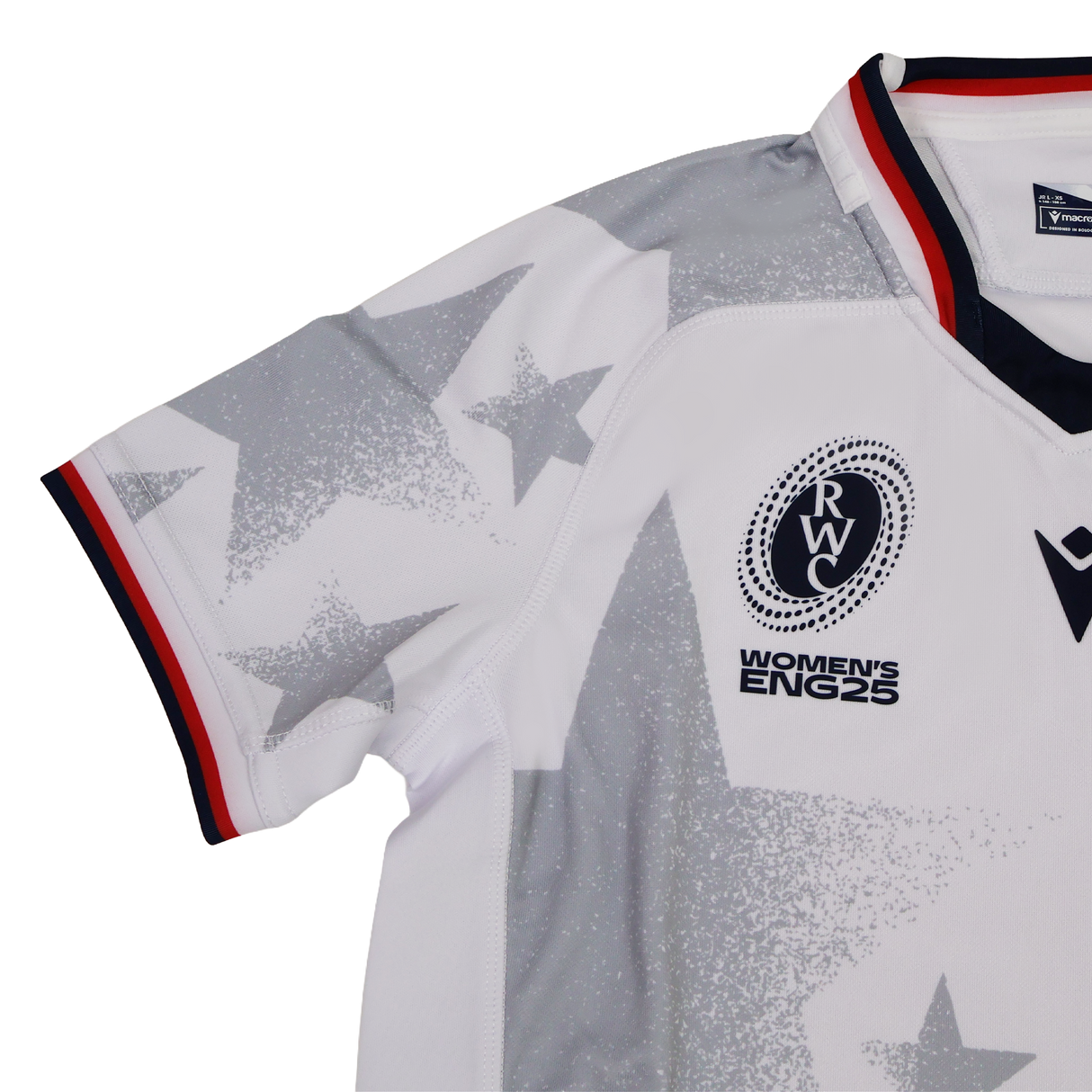 The Youth USA Rugby WRWC 25 Home Jersey by Macron features white fabric, gray star patterns, a red, white, and blue collar, and chest emblems reading “RWC,” “Women’s ENG25,” and “WRWC 25.”.