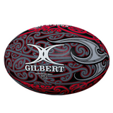 The Gilbert Maori All Blacks Supporters Ball features a unique black, red, and gray swirl design with the Gilbert logo—an ideal choice for any rugby fan.