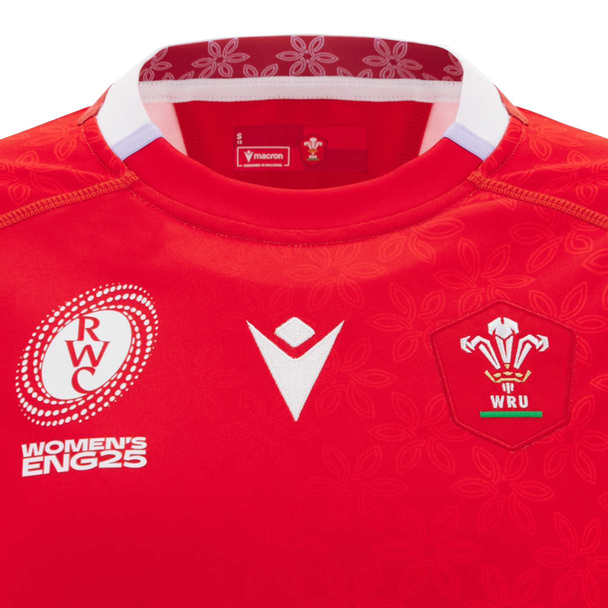 Close-up of the Women's Wales WRWC25 Replica Home Jersey by Macron, showcasing the WRU logo and RWC Women's ENG25 emblem on the chest.