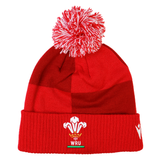 Show your support on match day with the Wales 25/26 Pom-Pom Beanie by Macron—a red knit beanie with a white and red pom-pom, featuring the WRU logo on the cuff.