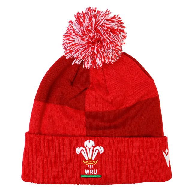 Show your support on match day with the Wales 25/26 Pom-Pom Beanie by Macron—a red knit beanie with a white and red pom-pom, featuring the WRU logo on the cuff.