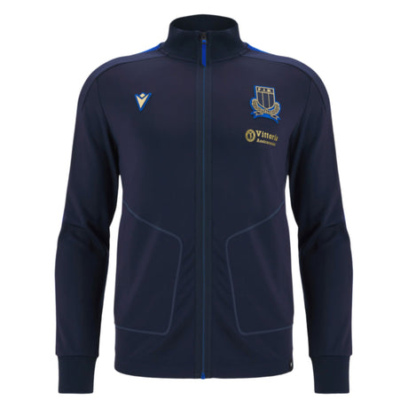 The Italy 25/26 Anthem Jacket by Macron features a navy blue zip-up design with a high collar, two side pockets, and embroidered chest logos, combining classic style and sporty elegance inspired by Italia Rugby.