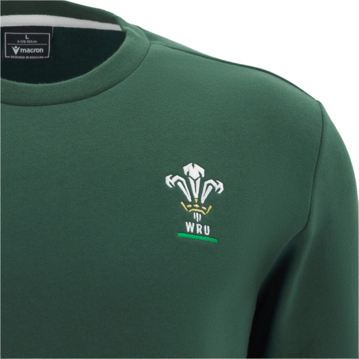 The Wales 25/26 Country Outline Fan Sweatshirt by Macron features a green design, iconic WRU three white feathers and text, and a Macron label inside the collar—ideal for any rugby supporter.
