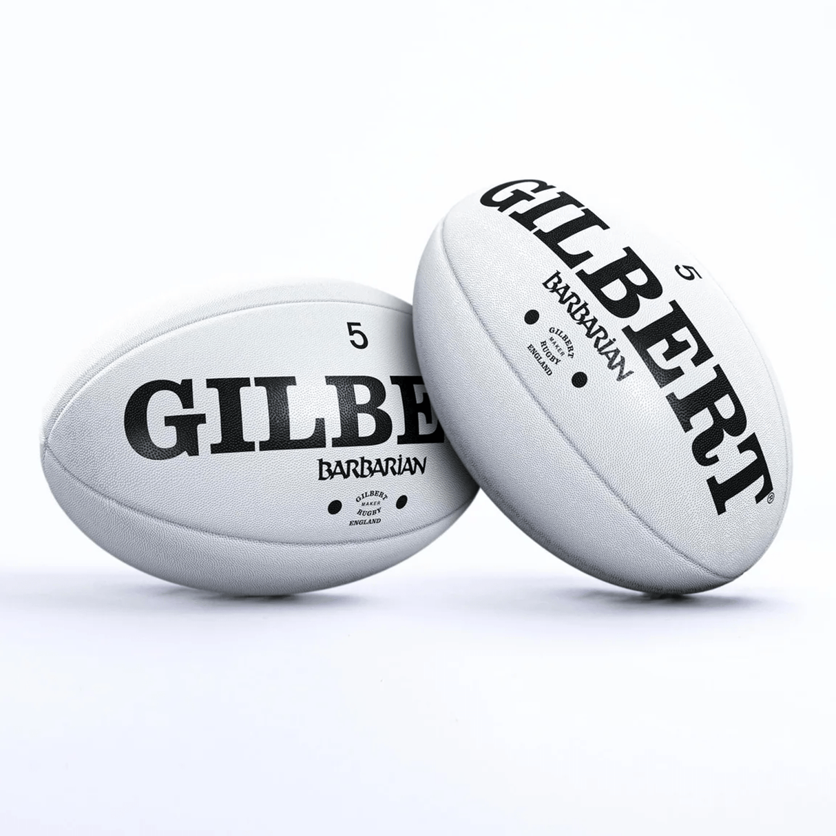 Two Gilbert Original Barbarian Match Balls with the brand name Gilbert on them.