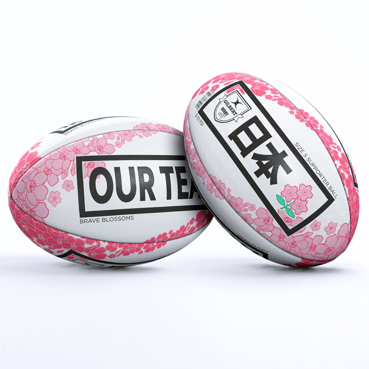 Two Japan Supporters Balls by Gilbert with cherry blossom designs feature "JAPAN" in English and Japanese on one, and "OUR TEAM BRAVE BLOSSOMS" on the other, making them perfect Japan Supporters Balls.