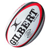A Gilbert Orion Match Ball in white with red and black accents, featuring the Gilbert brand name, logo, and “9.5-10 PSI” marking, designed as an official match rugby ball for superior performance.