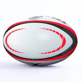 A Gilbert Orion Match Ball, featuring white panels with black and red curved patterns, is displayed on a white background.