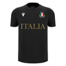 The Italy 25/26 Cotton Supporters Shirt by Macron is black, crafted from soft cotton, with "ITALIA" in gold, the Italian Rugby Federation crest on the left chest, and a Macron logo on the right.